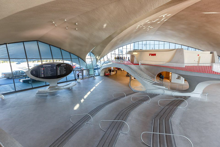 JFK Airport to Manhattan Transportation-7 Best Options 2 Daylight photo showing inside of the old TWA terminal at JFK Airport in NYC. The terminal is now a hotel. Shows space-age architecture with smooth, flowing curves.