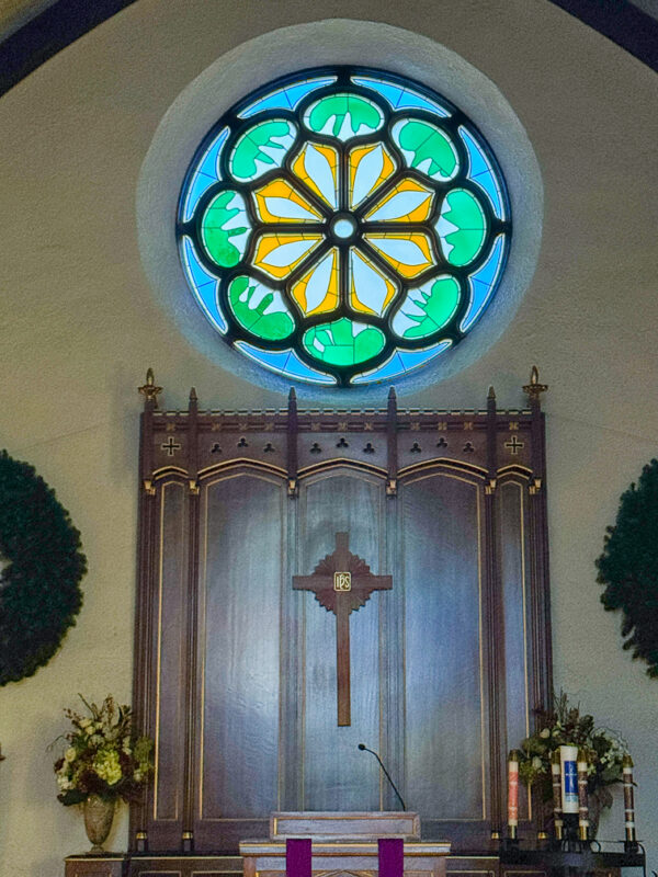 Matisse Rose Window illuminating church altar, ethereal light filtering through abstract design, creating transcendent spatial atmosphere