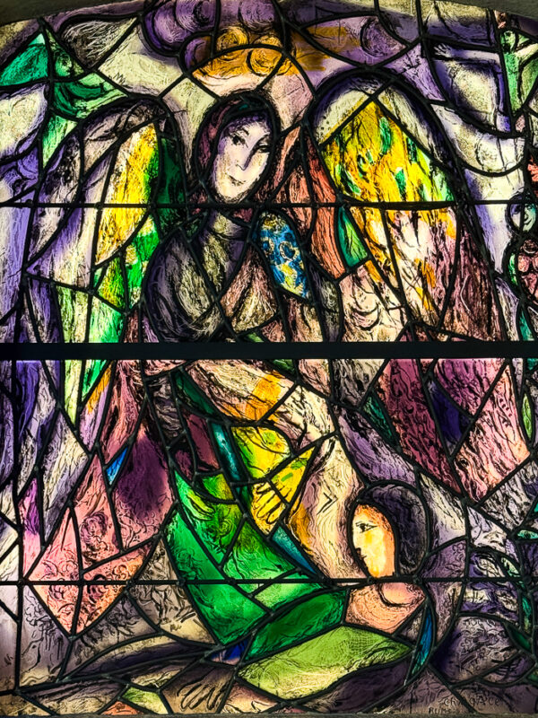 The Cherubim window at Union Church, designed by Marc Chagall, with welcoming angelic figures in bright yellows and blues.