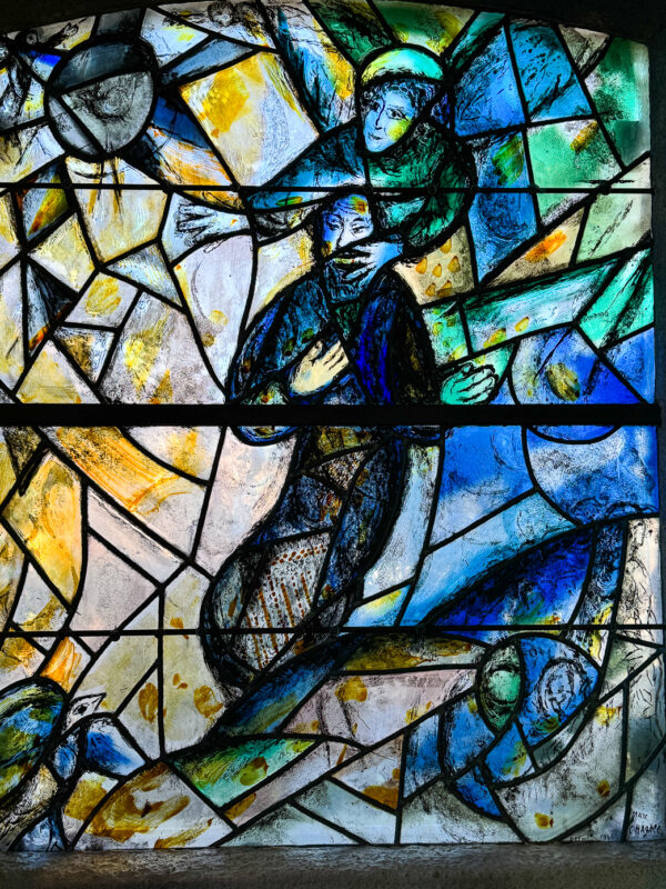 Marc Chagall's window illustrating the Prophet Isaiah, whose mouth is covered by the hand of an angel.