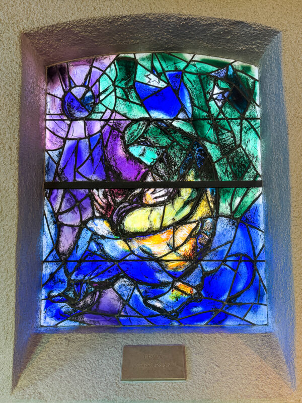The Prophet Jeremiah window by Marc Chagall, with a solitary figure surrounded by muted greens, symbolizing loneliness and despair.