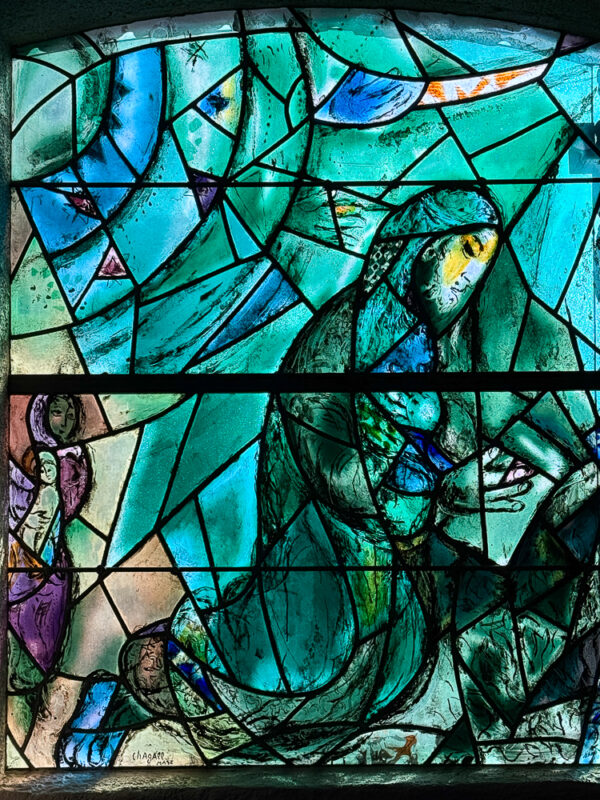 The Prophet Joel window by Marc Chagall, with a meditative prophet framed by bold contrasts and symbolic imagery.